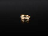 an image of a gold ring on a black surface