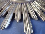a large metal sunburst on a blue cloth