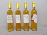 three bottles of wine are lined up on a table