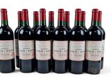 six bottles of red wine are lined up in a row