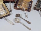 a lot of silverware in a case on a table