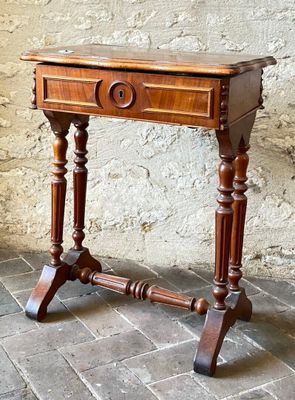 a small wooden table with a drawer on top of it