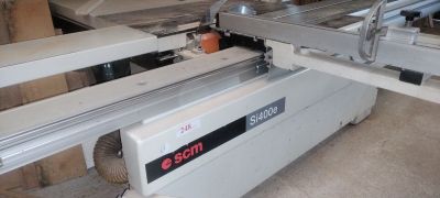 a machine that is cutting a piece of wood