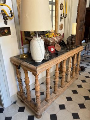 a table with a lamp on top of it in a room