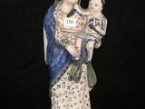 an image of a statue of a woman holding a child