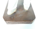 a statue of a man standing on top of a wooden block