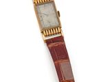 une photo d'une montre-bracelet posée sur une surface blanche