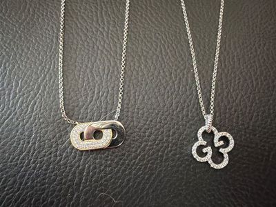 a couple of necklaces that are sitting on top of a table