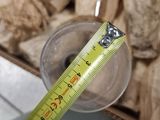 a measuring tape that is on top of a glass