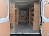 a white van that has some shelves inside of it