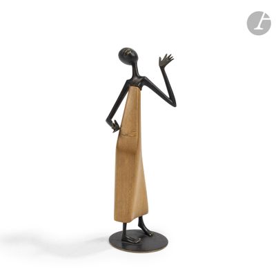 a statue of a woman in a dress is standing on a pedestal