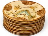 a stack of plates with birds on them on a white surface