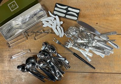 a lot of utensils and spoons sitting on a table