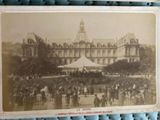 an old photo of a crowd of people in front of a building