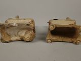 pair of ceramic figurines of a dog and a cat on a log
