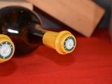 two bottles of wine sitting on a red table