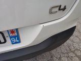 a close up of a white car with a number plate on it