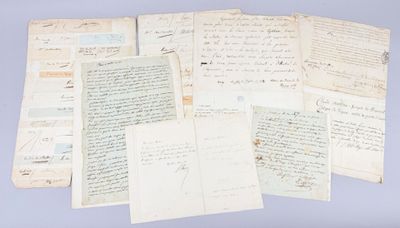 several old papers are stacked on top of each other on a blue surface