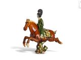 a figurine of a woman riding a horse