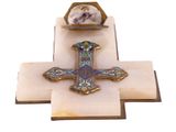 a cross that is sitting on top of a book