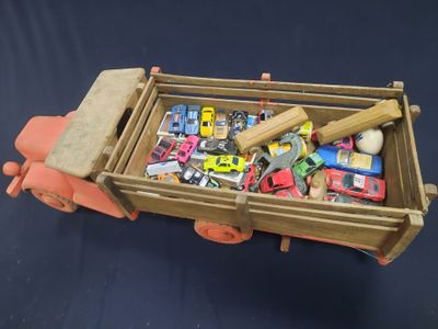 a toy truck with a lot of toy cars in it