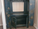a blue cabinet with a mirror on it in a room