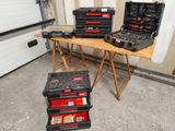 three tool boxes sitting on a table in a garage