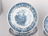 several blue and white plates are stacked on top of each other
