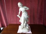 a statue of a woman that is standing on a table