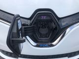 a close up of an electric vehicle plugged into a charging station