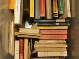 many books in a plastic container on the floor