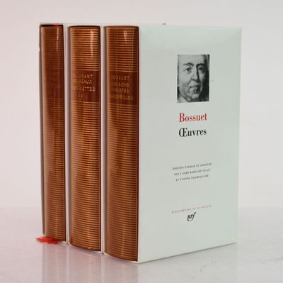 three books sitting on top of a white table next to each other