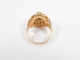 a close up of a gold ring on a white surface