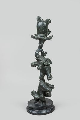 an image of a statue of a bird on top of a tree