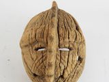 an image of a walnut nut with a face carved into it