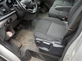the interior of a car with the door open and the driver ' s seat down