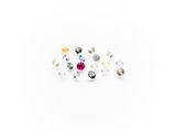 a bunch of different colored stones sitting on top of a white surface