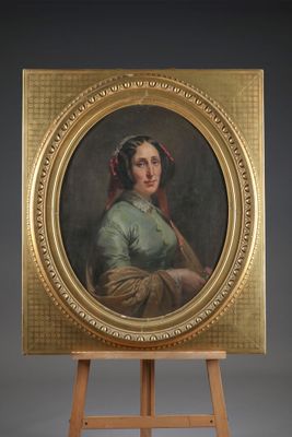 an oil painting of a woman in a green dress on a wooden easel