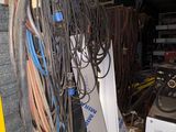 a pile of wires and other electrical equipment in a garage