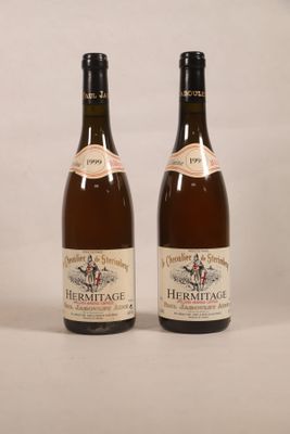 two bottles of wine sitting next to each other on a table