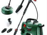 a close up of a green and black power washer and a brush