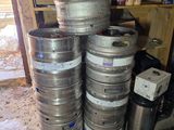 several kegs stacked on top of each other in a garage