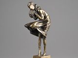 bronze statue of a woman holding a bird on a marble base