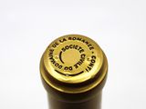 a bottle of wine that has a gold cap on it