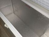 a bath tub that is in the middle of a tiled floor