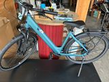 a blue bicycle that is parked in a garage