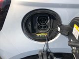 a close up of a car charging at a gas station