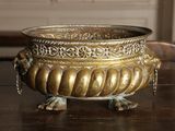a large metal bowl on a table with a chain around it