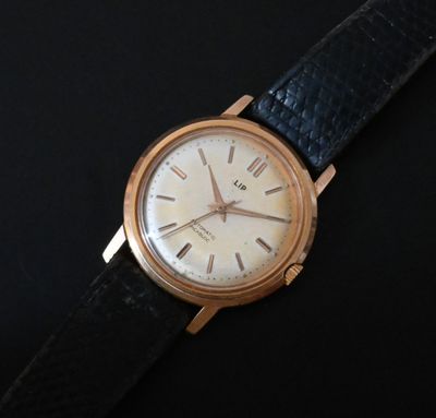 a close up of a watch on a black surface
