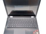 a laptop that is open on a white surface